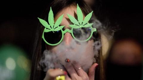 An Israeli woman smokes marijuana during a demonstration calling for the legalisation of cannabis in Tel Aviv, Israel, 4 February.