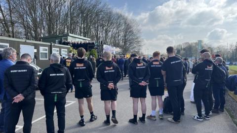 Rugby players congregated at the memorial.