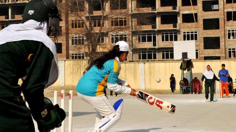 Afghan girls play cricket on the school grounds in Kabul on December 28, 2010