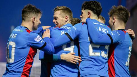 Inverness players celebrate after an own goal makes it 4-1