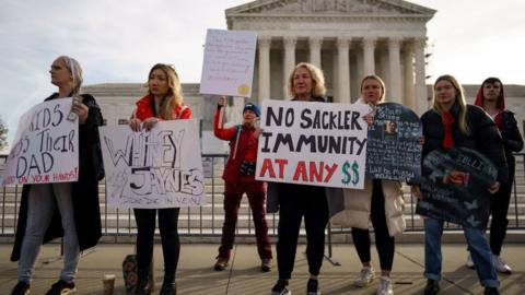 People gather outside of the US Supreme court to protest Purdue Pharma's bankruptcy deal