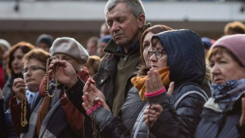 People pray on Poland's eastern border with Belarus