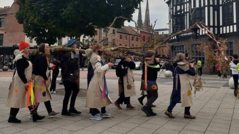 Female artists carrying the trunks through Coventry