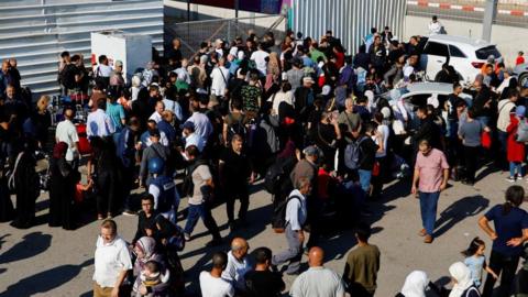 Palestinians with dual citizenship gather outside Rafah border crossing with Egypt - 16 October 2023