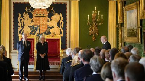 Alex Maskey speaks to King Charles and Camilla inside Hillsborough Castle