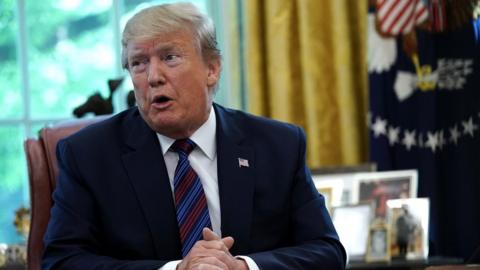 President Donald Trump speaks to members of the press at the White House