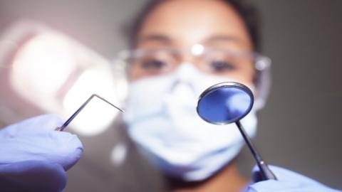 Dentist holding instruments