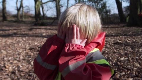 Child playing hide and seek