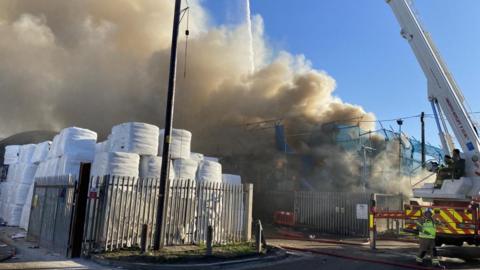 Large amounts of smoke pouring out of a recycling centre in Essex.