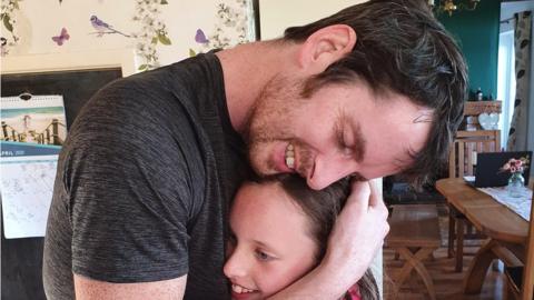 Stephen hugging his daughter