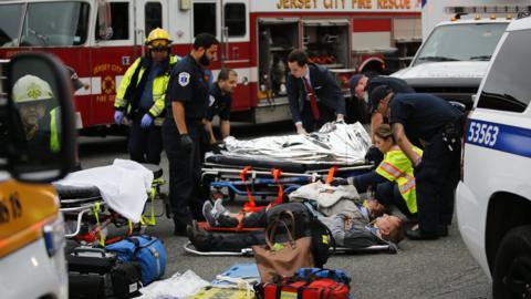 Paramedics treat injured commuters at Hoboken station on 29 September 2016