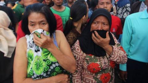 people looking at the firecracker factory that burned down