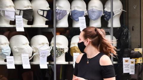 Woman looking at masks in shop