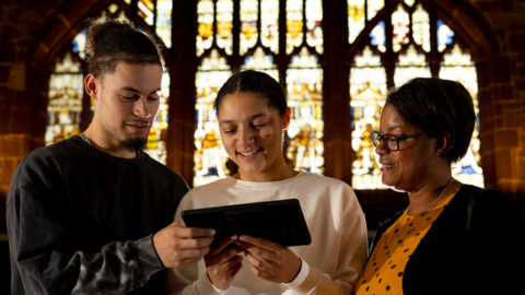 People looking at a tablet in the Guildhall