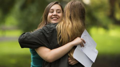 Caitlin Hannah hugs a fellow pupil after receiving 2 As and an A* in her A Level results at Ffynone House School on August 17, 2017 in Swansea