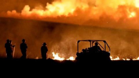 Firefighters fighting moorland fire