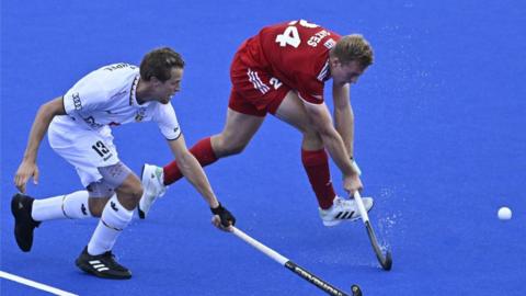 Belgium's Nicolas de Kerpel and England's James Oates compete for the ball during their EuroHockey Pool A opener