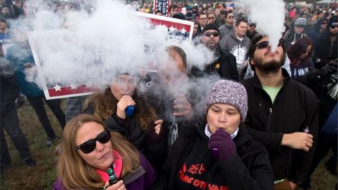 Demonstrators vape during a consumer advocate groups and vape storeowners rally outside of the White House to protest the proposed vaping flavor ban in Washington DC on 9 November 2019.