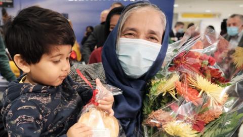 Aysha Patel is re-united with her grandson as passengers arrive from the first British Airways flight to arrive since the US lifted pandemic travel restrictions, on 8 November 2021 in New York City