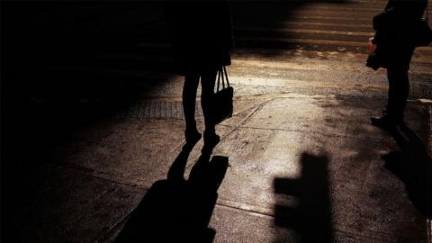 Silhouette of woman in street