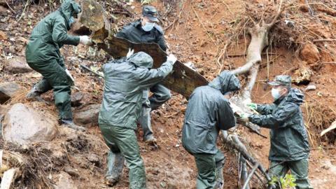 Rescuers at the site of the China Eastern Airlines plane crash.