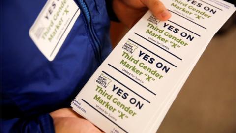 Stickers are seen promoting a campaign to allow for a third gender option on Oregon identity cards.