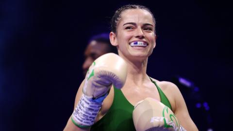 Skye Nicolson smiles with her mouthguard showing in the ring