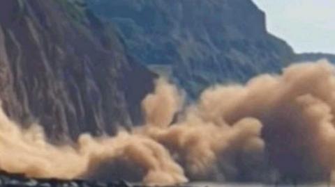 A series of cliff falls has sent huge clouds of dust into the air at a seaside resort. The first fall at Sidmouth in Devon was reported to Solent coastguards at 09:30 BST.