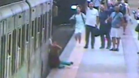 The woman is dragged along the platform of a Rome metro station
