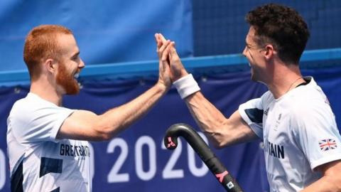 Jack Waller celebrates with Great Britain hockey team-mate Phillip Roper