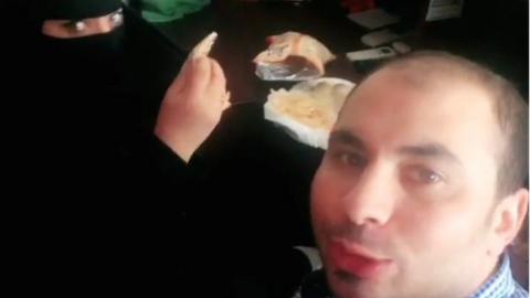 A close up of the video showing the man and woman having breakfast together.