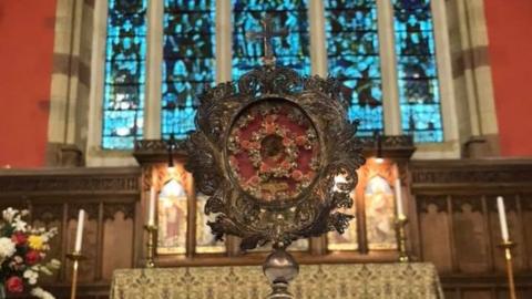 The supposed relic on temporary display at St Peter's in a centre of a silver display stand called a monstrance