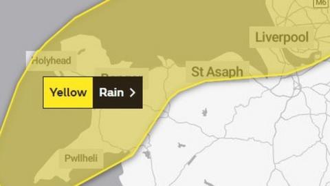 Map showing a yellow rain warning across the coastal areas of north Wales