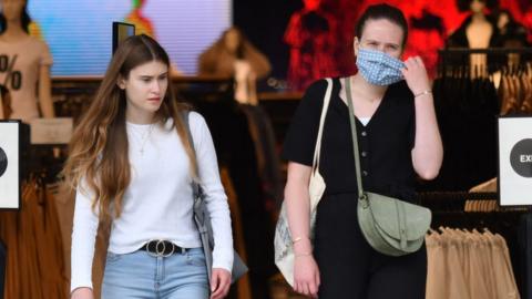 Women in shop wearing masks