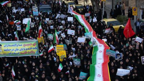Iranian pro-government supporters march during the funeral of a young member of the Revolutionary Guards, Sajjad Shahsanai, in the city of Najafabad, west of Isfahan, on Wednesday