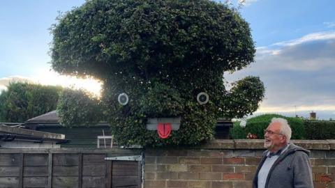 Mike Bone smiling at the tree