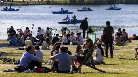 LONDON, ENGLAND - JUNE 05: Young people socialising in Regents Park early evening on June 05, 2021 in London, England.