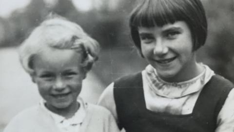 A black and white photo of mother and daughter