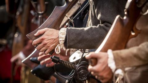 Re-enactors armed with arquebusiers