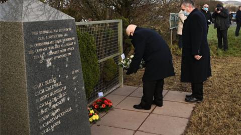 Tributes are left at Teebane memorial