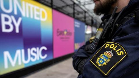 Police in front of a Eurovision sign