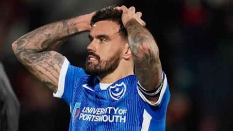 Portsmouth players react to their defeat by Cheltenham