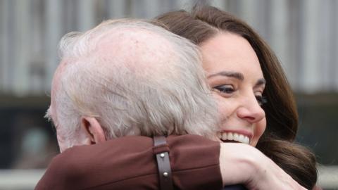 The Duchess hugs former teacher Jim Embury