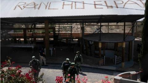 Soldiers patrol at a clandestine cockfighting ring following the killing of at least 20 people on Sunday night during an attack, authorities said, in Zinapecuaro, Mexico March 28, 2022.