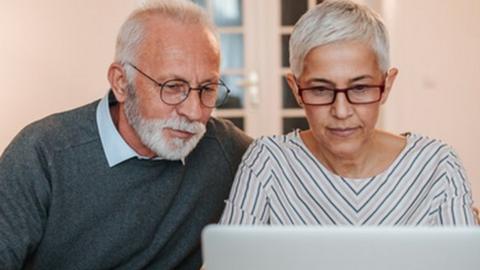 Couple looking at a computer and finances