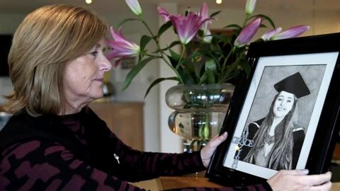 Gillian Millane looking at a photo of Grace