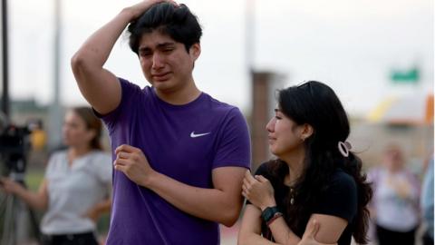 Crying people at a memorial