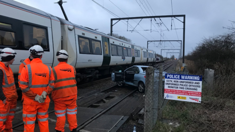 Car and train on tracks