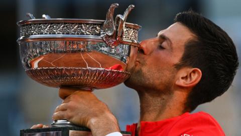 Novak Djokovic kisses the French Open trophy