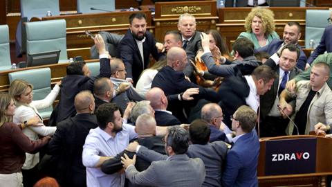 Kosovo opposition lawmakers clash with ruling members in the Kosovo parliament on 13 July 2023